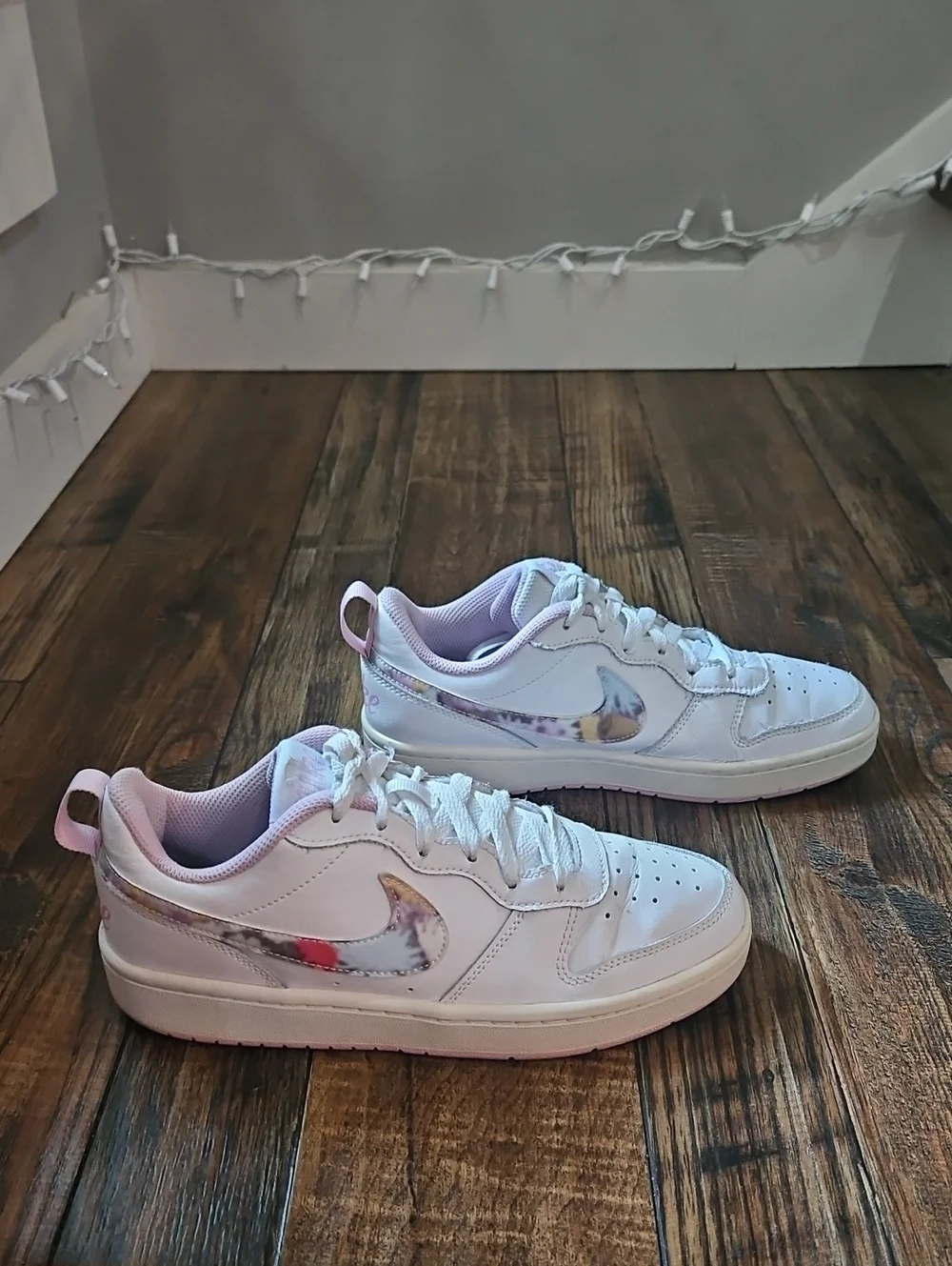 Nike White Low-Top Sneakers with Marbled Swoosh and Pink Details